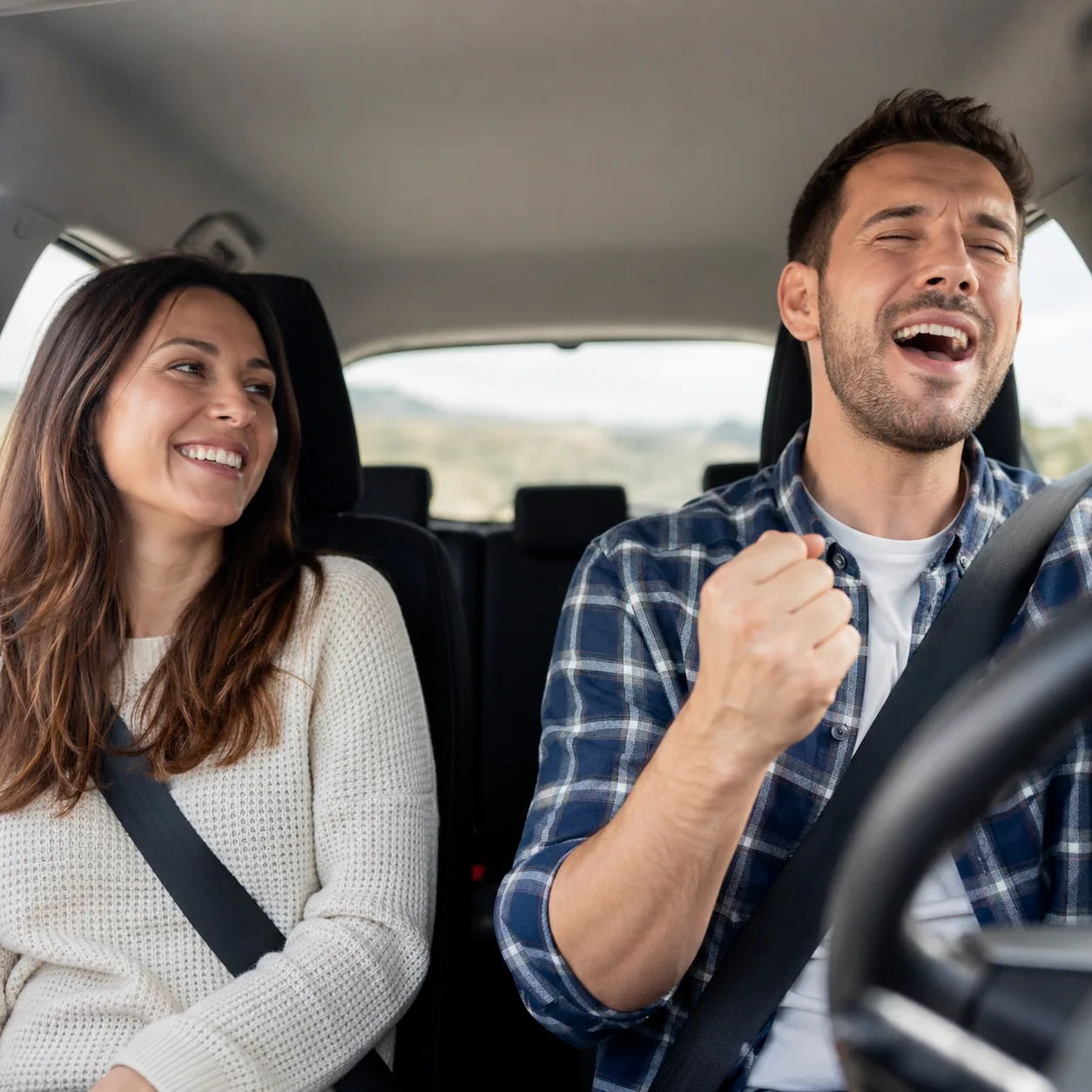 Cozy realistic lifestyle photo of a husband driving while singing along happily to the radio, wife smiling beside him