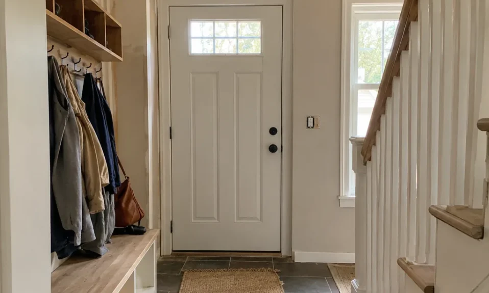 Realistic editorial photo of an American entryway showing designing entry last