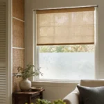 Realistic editorial photo of a room with windows, shades, shutters, woven panels, privacy film, and soft natural light showing tension rod used as a permanent f